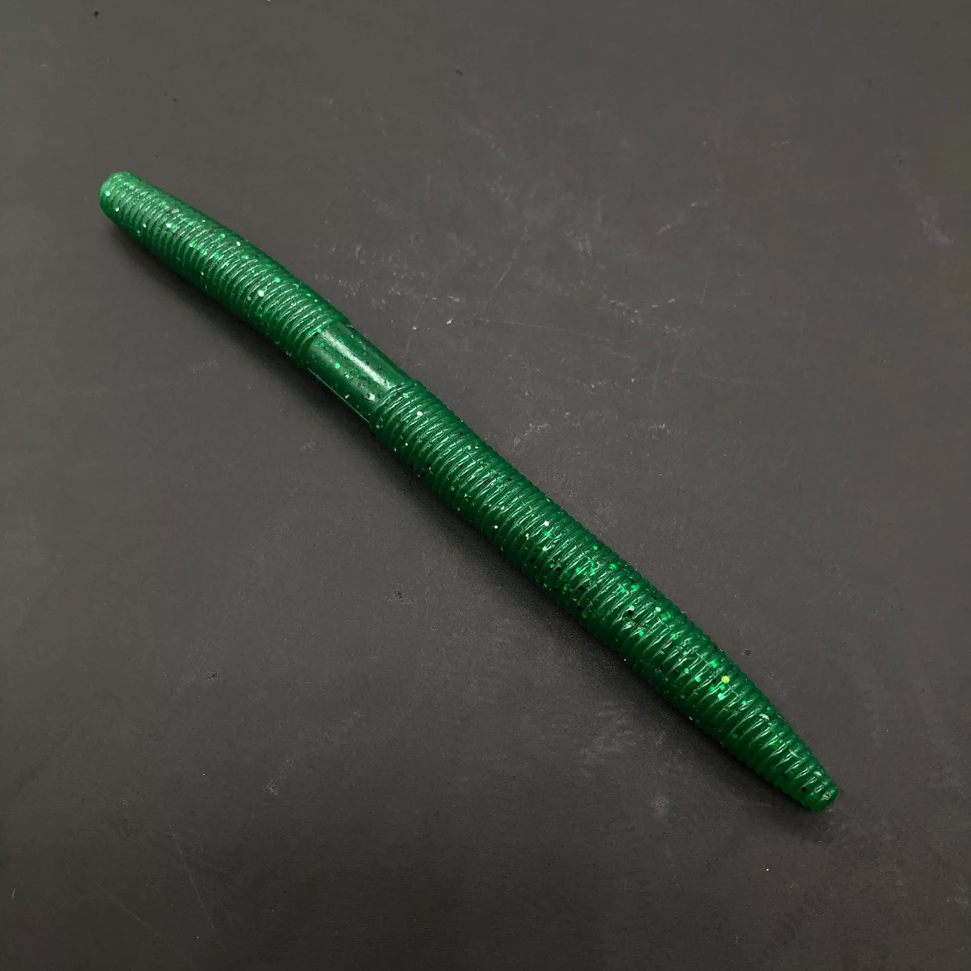 Soft plastic stick bait worm, bright green with glitter speckles