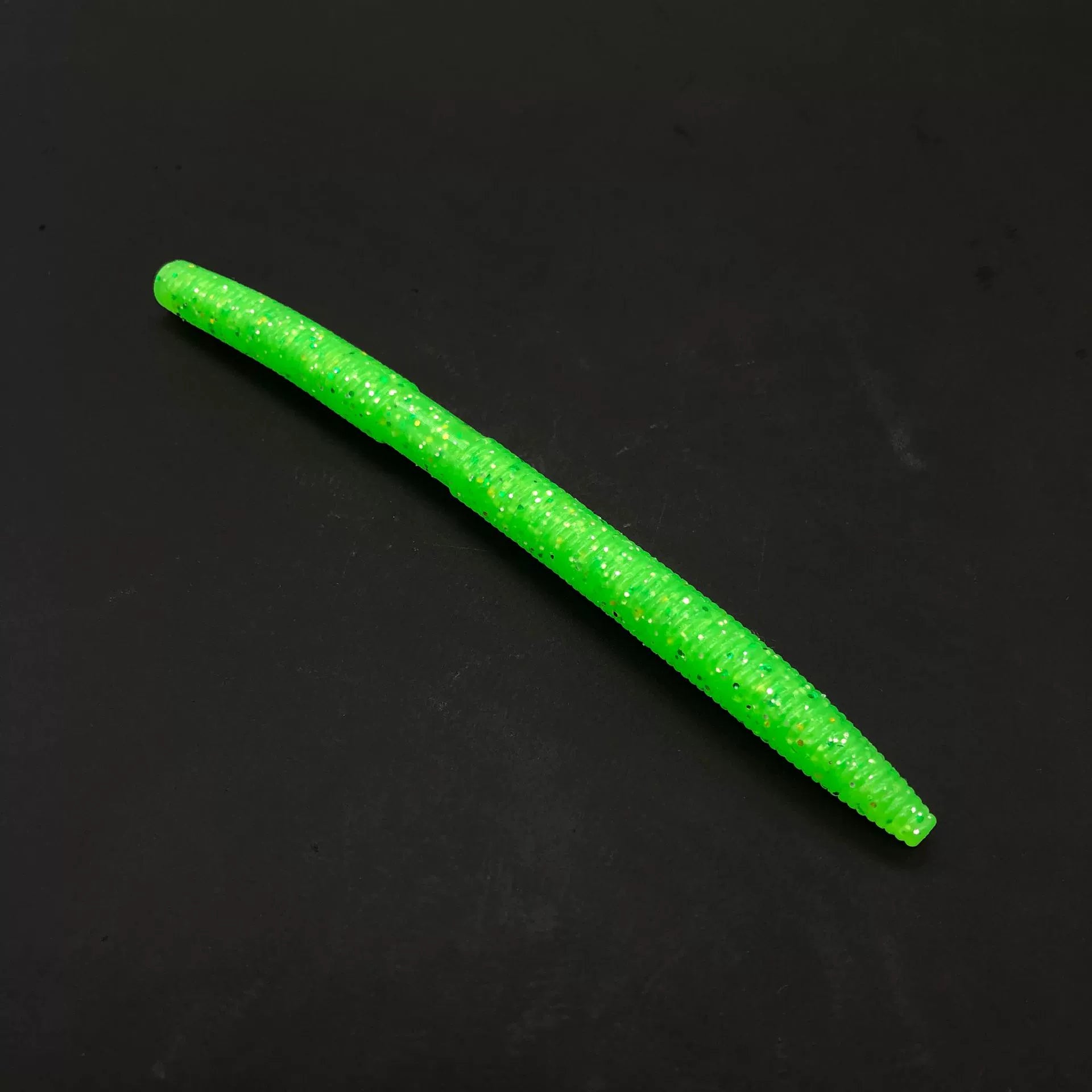 Soft plastic stick bait worm, lime green with glitter speckles