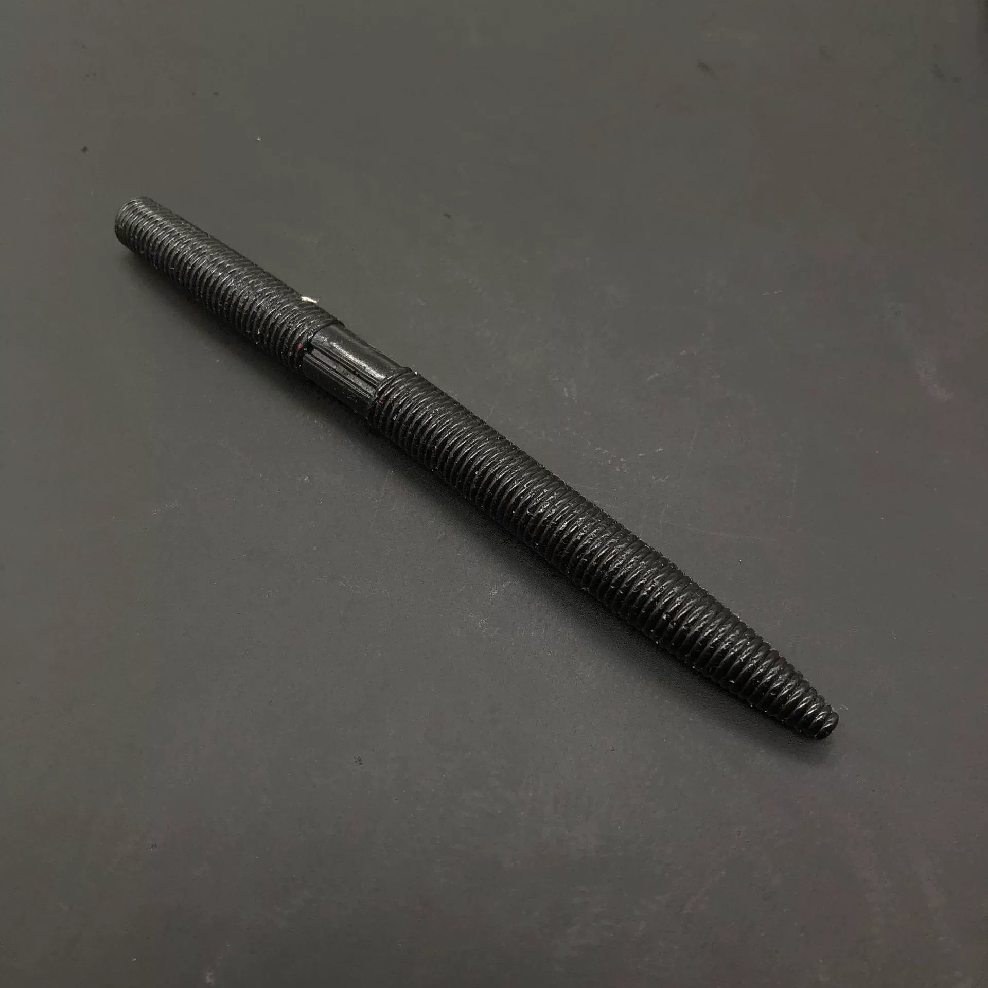 Soft plastic stick bait worm, black with ribbed texture
