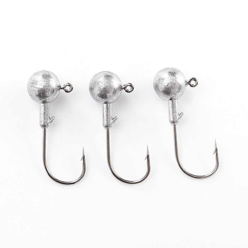 Three weedless jig head hooks with round lead balls and wide open hooks