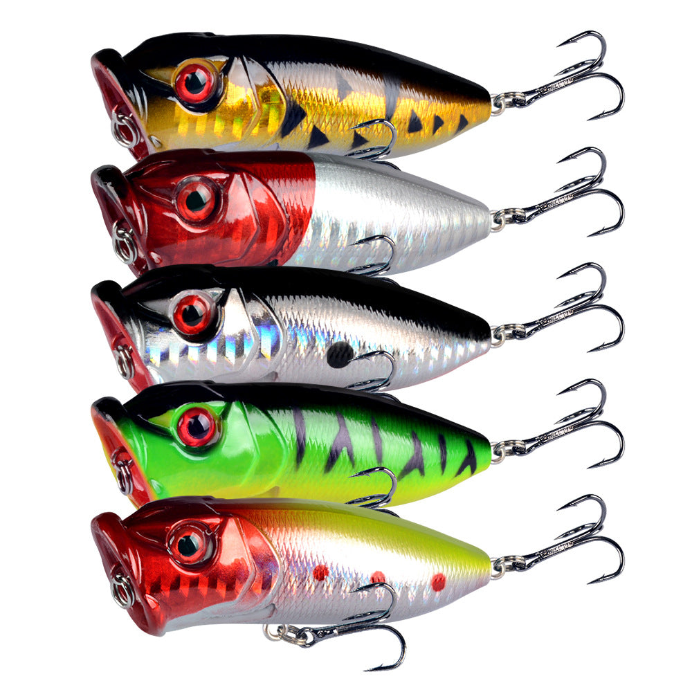 Assorted topwater popper lures with treble hooks and 3D eyes in mixed colors
