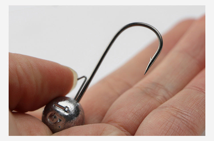 Ned rig jig head held in hand with round lead weight and barbed steel hook