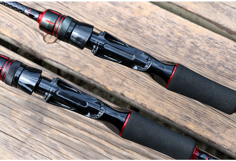 Two fishing rods with black reel seats and red accent bands