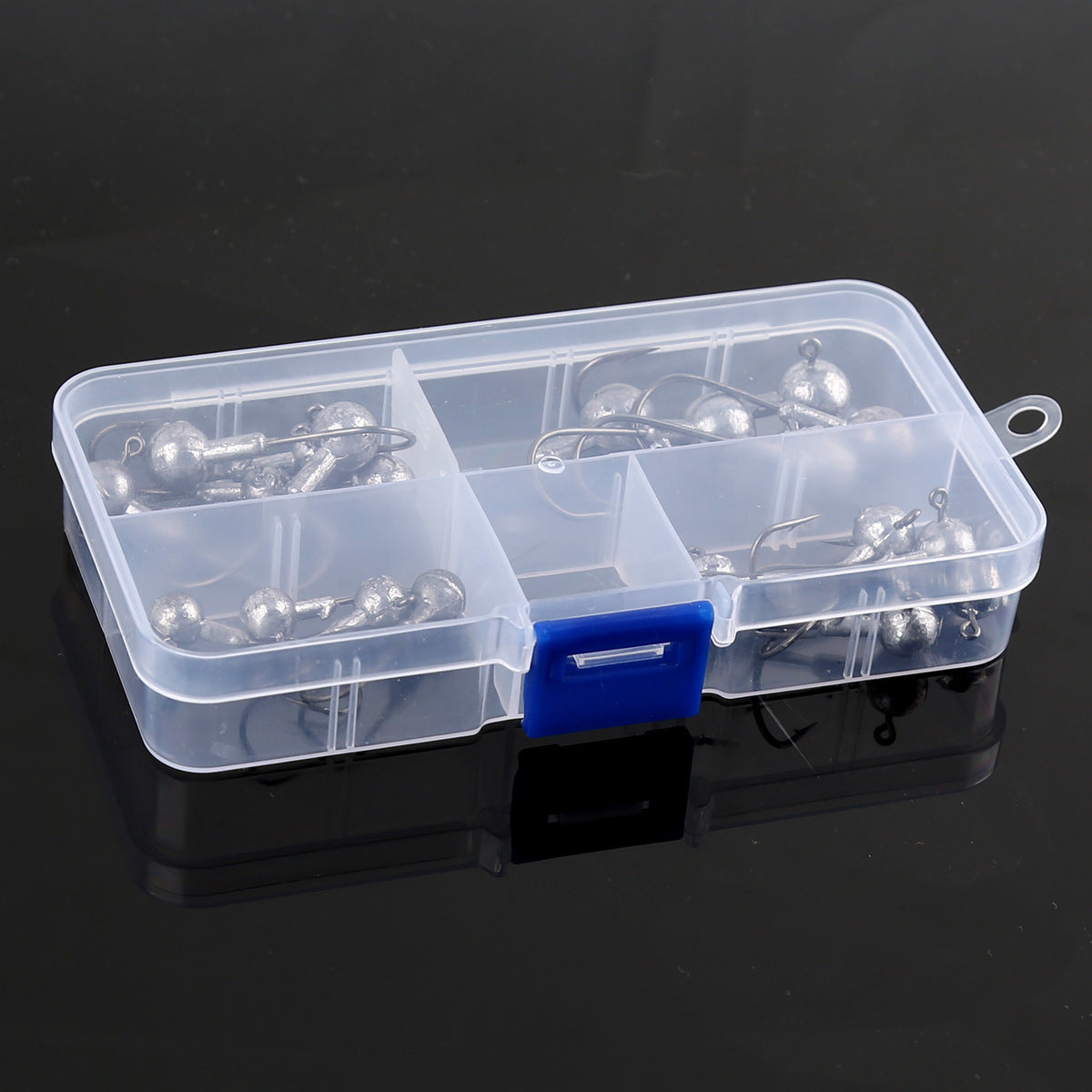 Tackle box holding multiple weedless jig head hooks with round lead balls