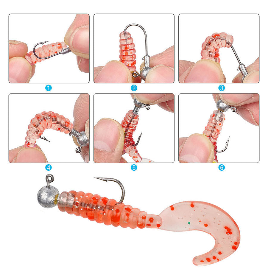 Weedless jig head hook threaded with red segmented soft bait worm, hands shown