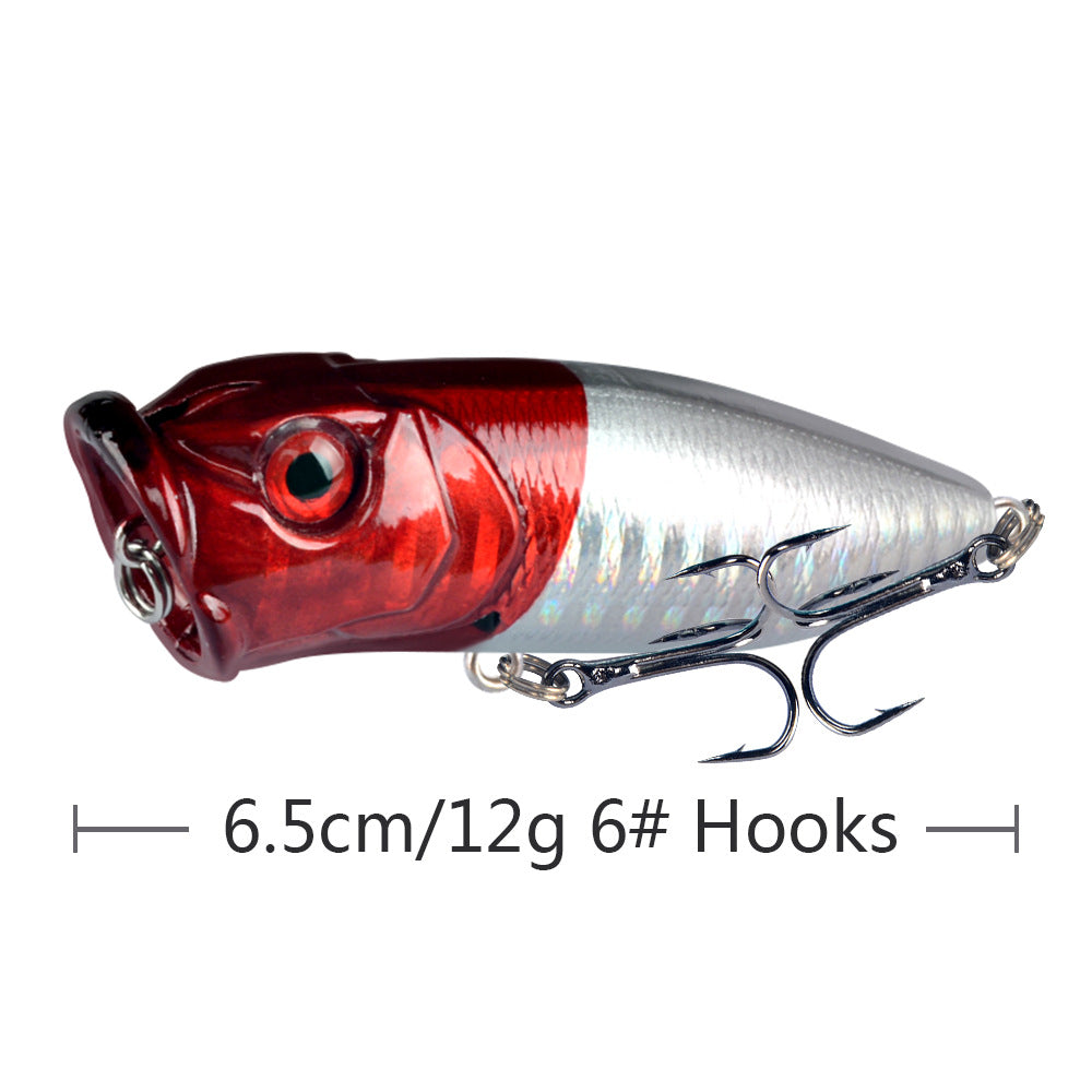 Red and silver topwater popper lure with treble hooks and reflective scale details