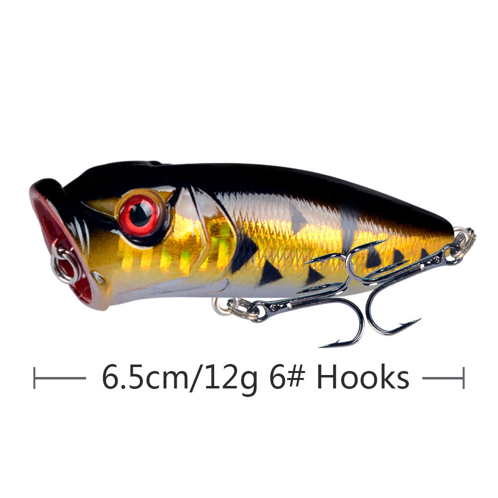 Gold and black topwater popper lure with treble hooks and 3D eyes